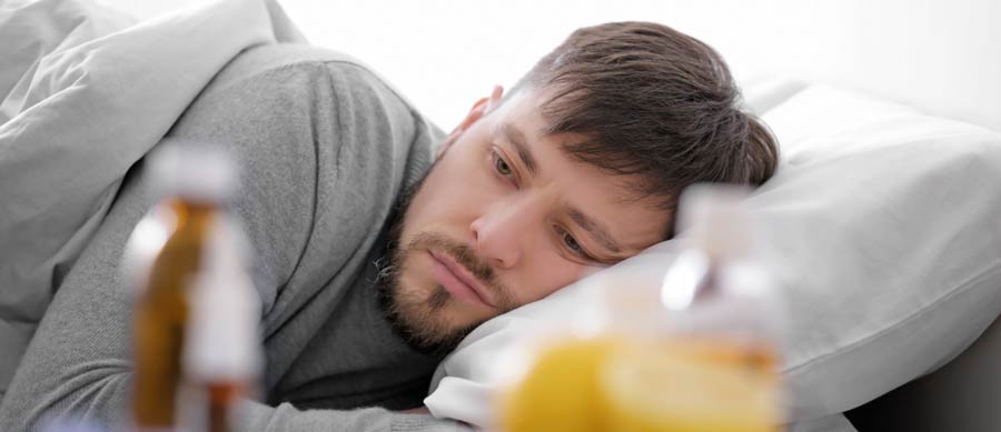 man suffers from withdrawal symptoms in bed