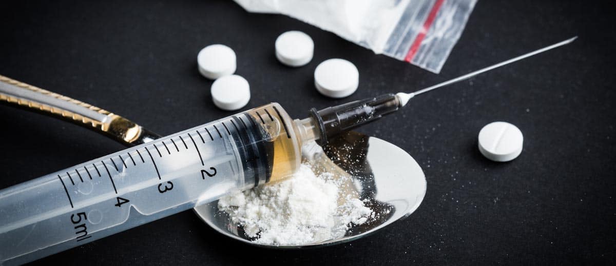 heroin powder and syringe