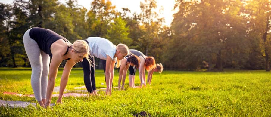 women doing yoga in a field