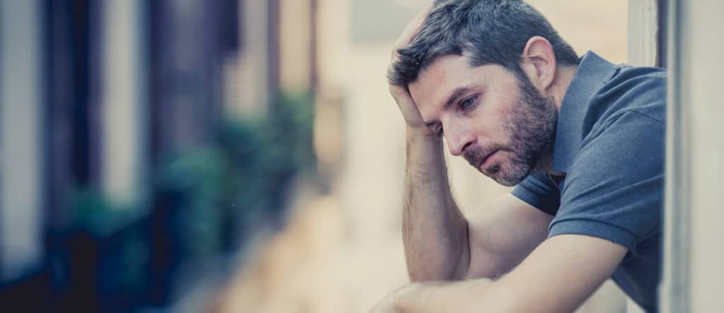 depressed man on balcony