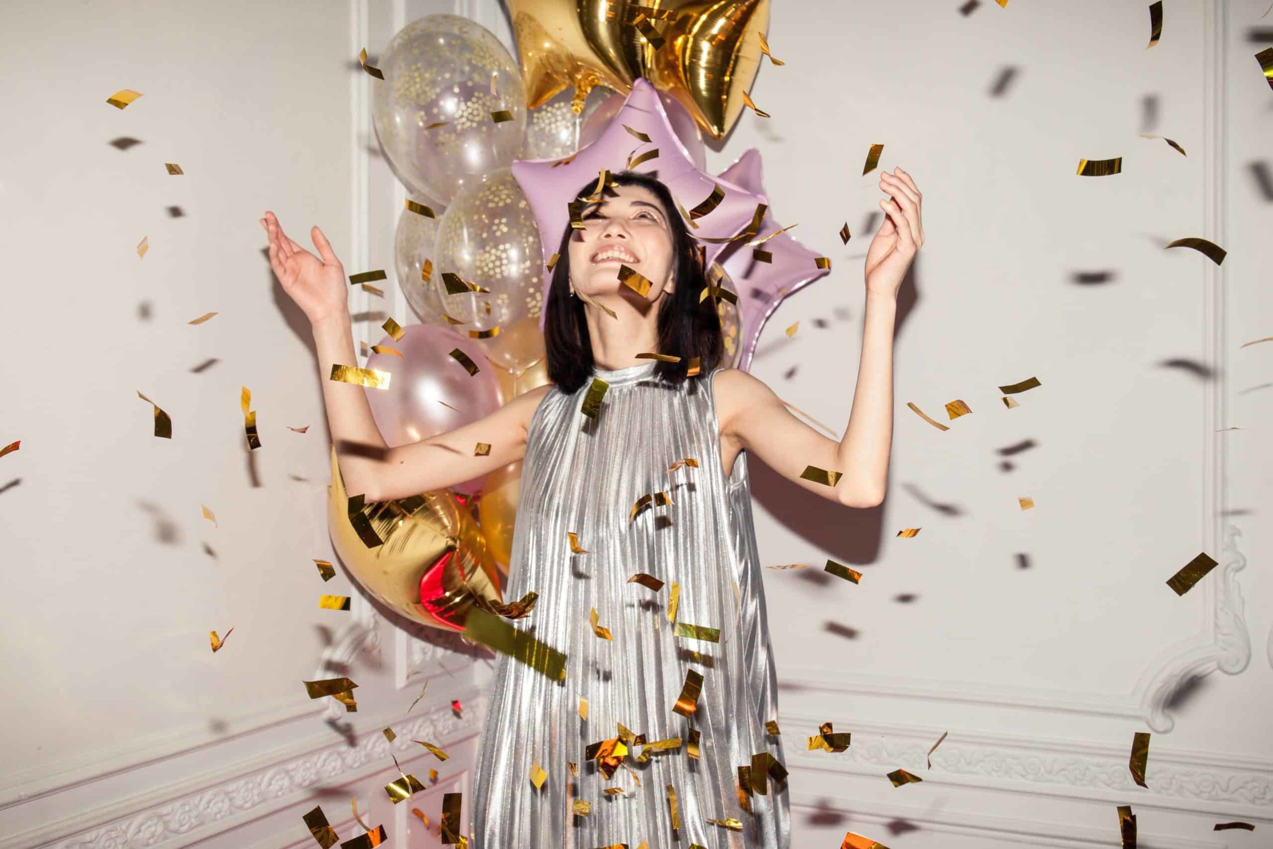 Woman with confetti celebrating recovery