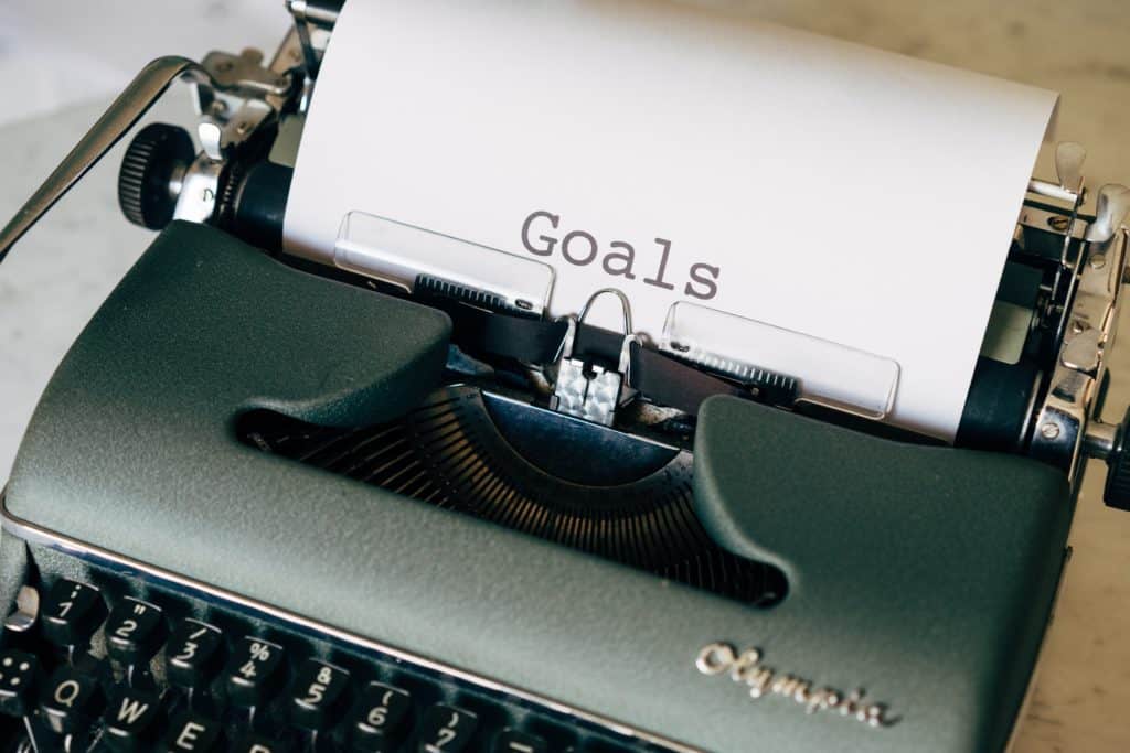 Typewriter typing the word 'goals.'