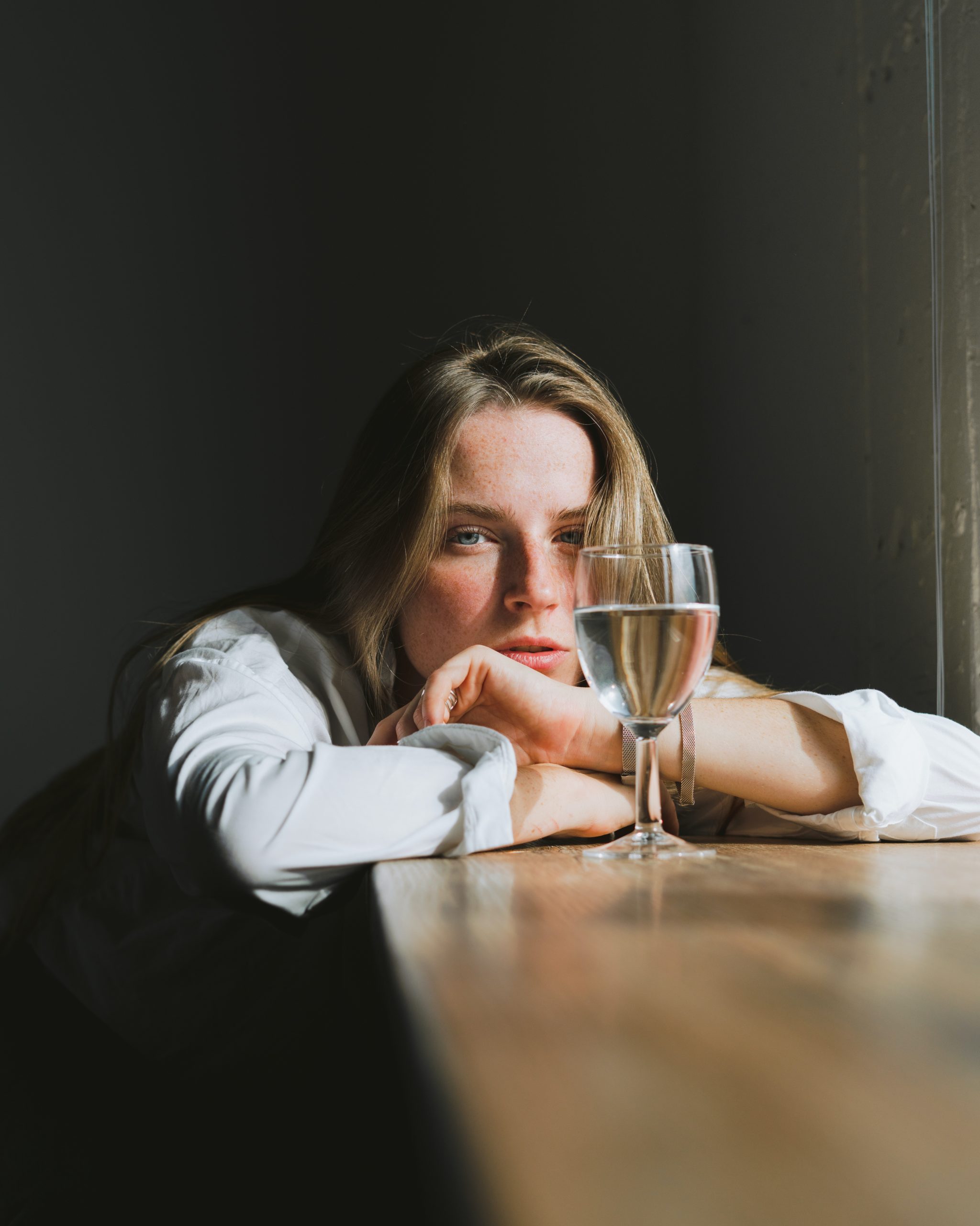 Woman alone with a glass of wine.